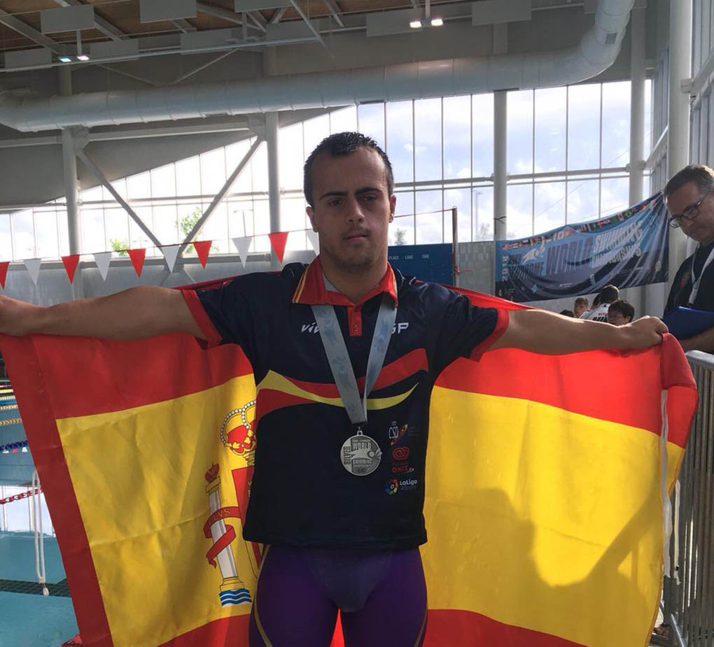 Eloy Molina posando con su flamante medalla y la bandera de España.