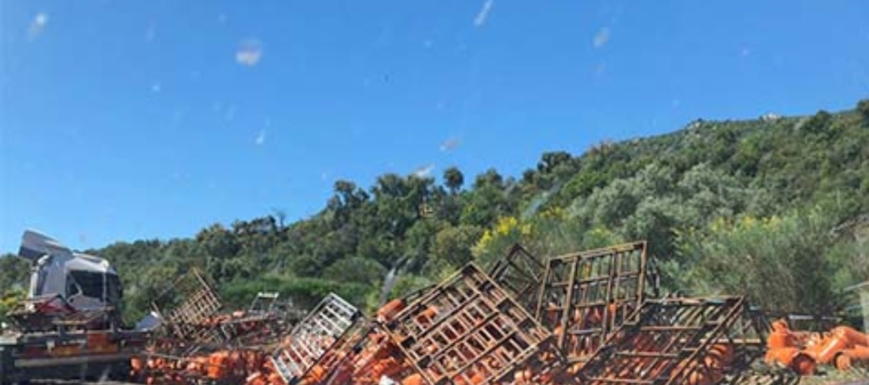 Las bombonas de butano han quedado esparcidas por la carretera, que ha tenido que ser cortada al tráfico.