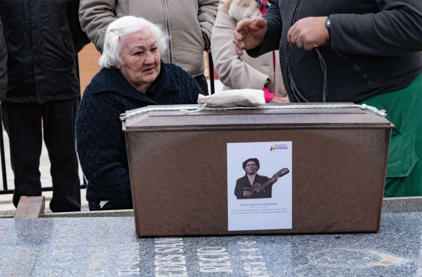 Agustina, junto a los restos de su padre, localizados en una fosa común en Recas. Foto: ARMH.