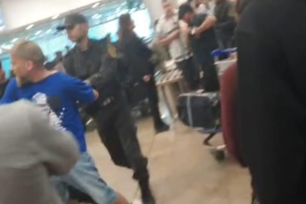 Un agente de policía agarrando a un hombre en el aeropuerto de El Cairo (Egipto). Foto: plataforma Toledo por Palestina