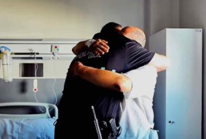 Abrazo entre el policía local de Toledo y el paciente al que salvó la vida.