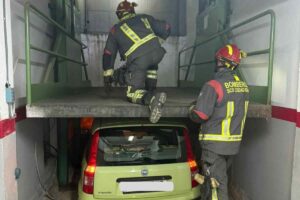 Los bomberos tratando de rescatar a los ocupantes del vehículo